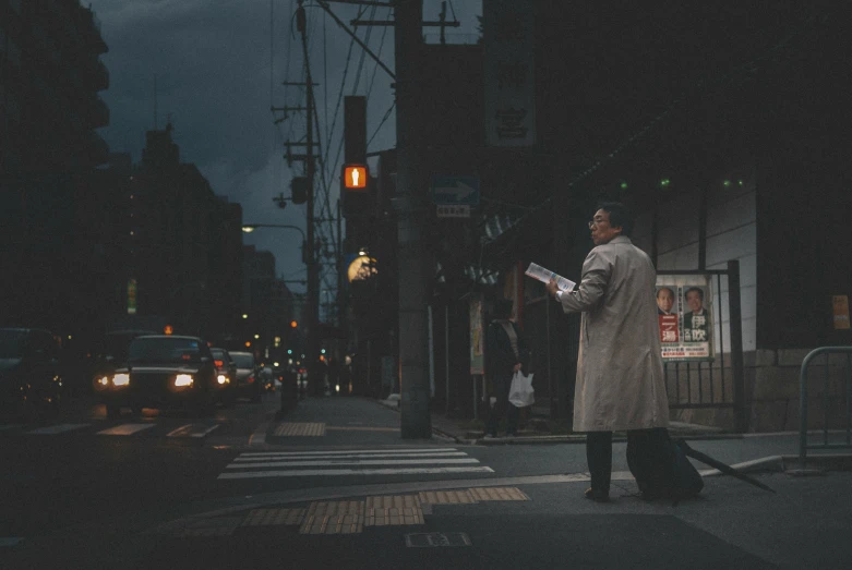 a man on the street looking at papers