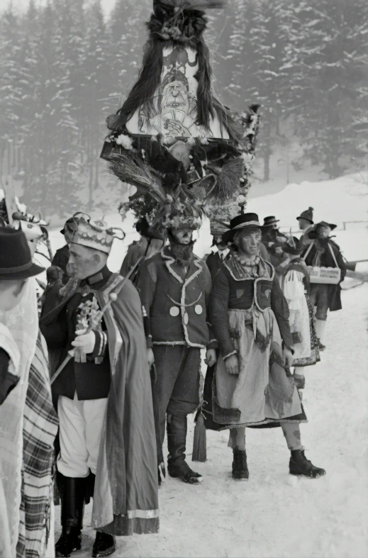 a parade of people wearing fancy clothing during the day