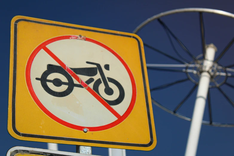 a no bikes sign is attached to a pole