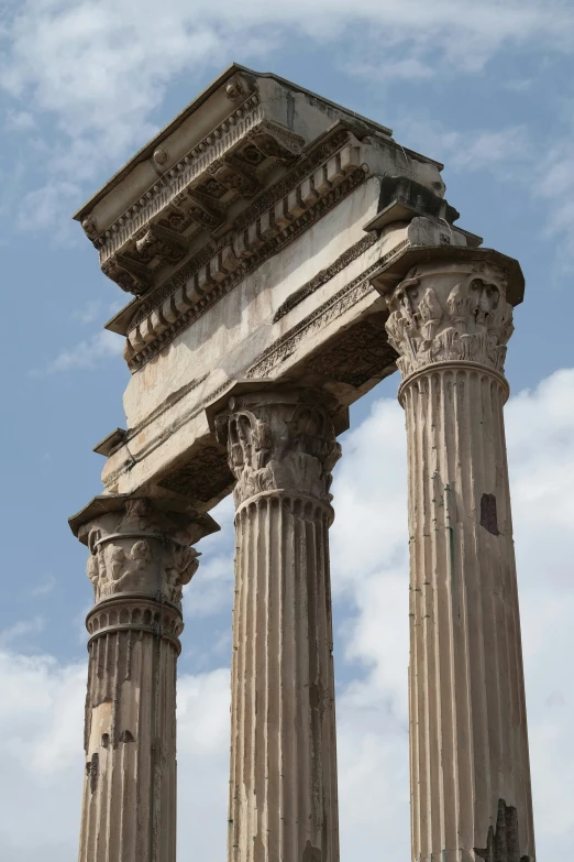 a stone and stucco columns with multiple pillars in front