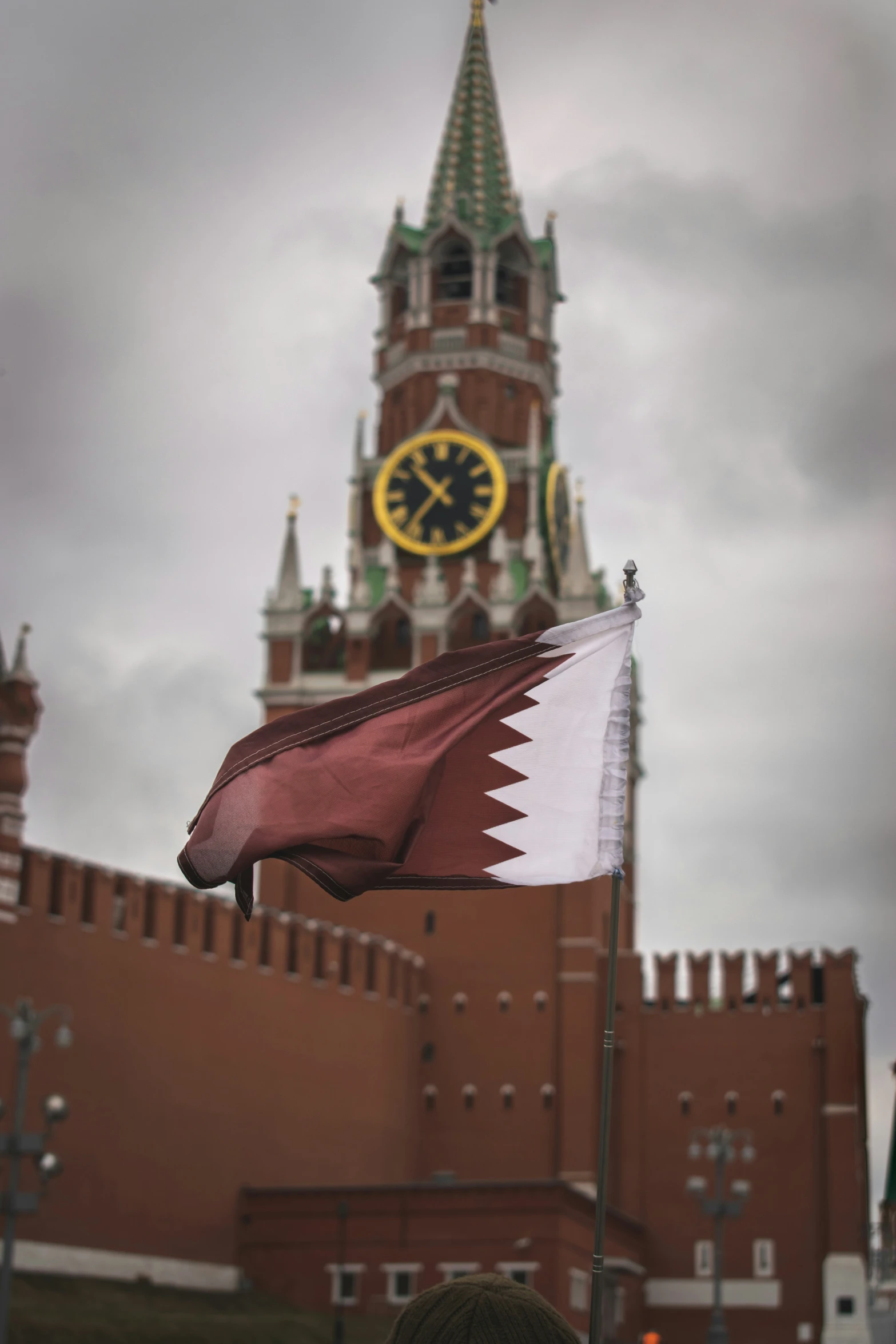 a flag with a large building behind it