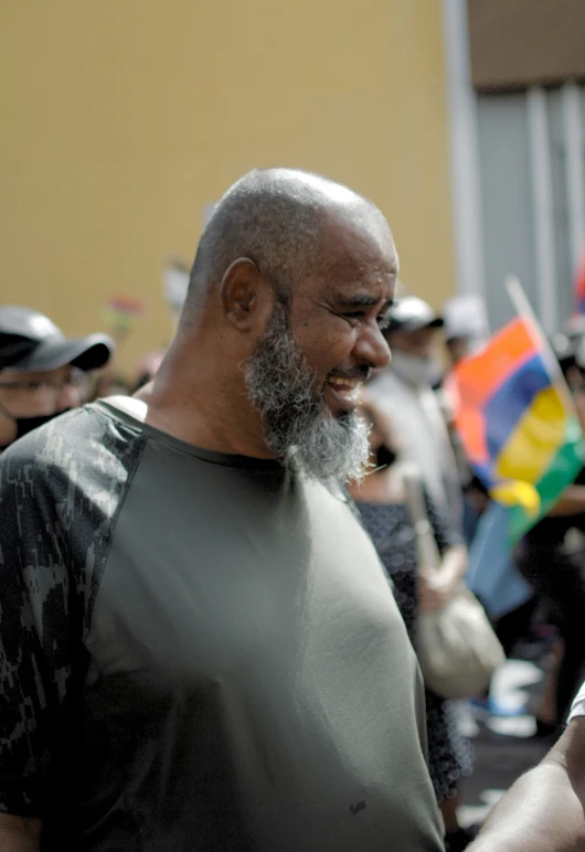 a man in grey shirt holding a cell phone