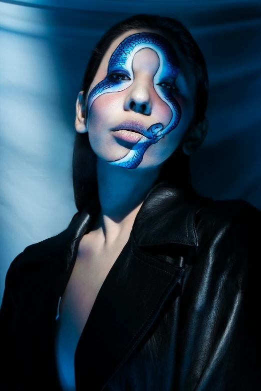 a girl in a black leather jacket with body art and face paint