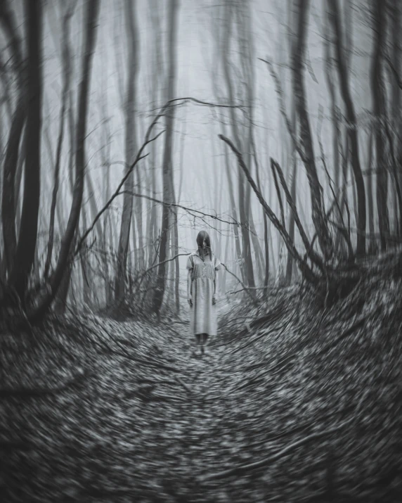 woman with umbrella standing in the woods in black and white