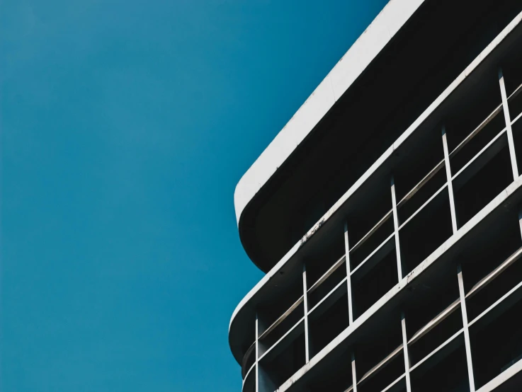 the corner of an apartment building against a blue sky