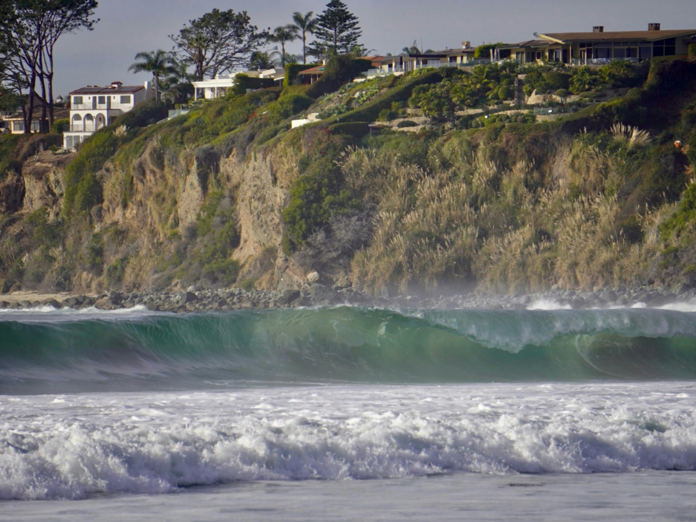 a big wave crashing in to the shore