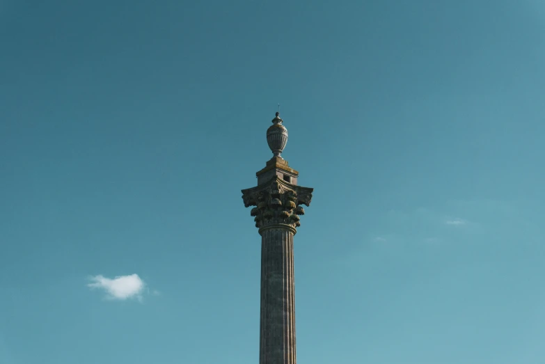 there is a tall spire with a clock on top