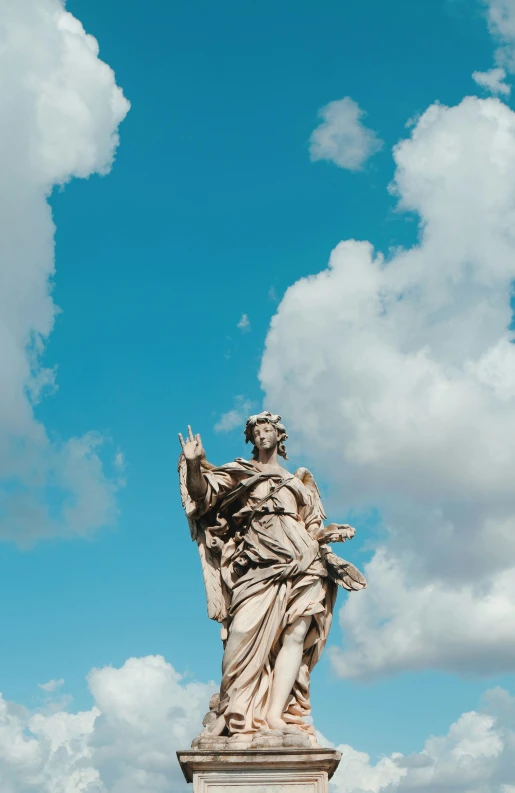 the statue of liberty is in front of clouds and blue sky