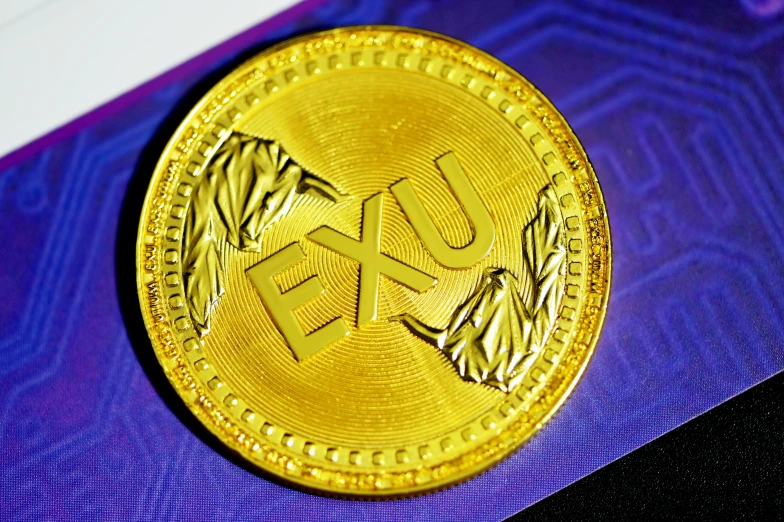 a close up of a gold coin on a purple cloth