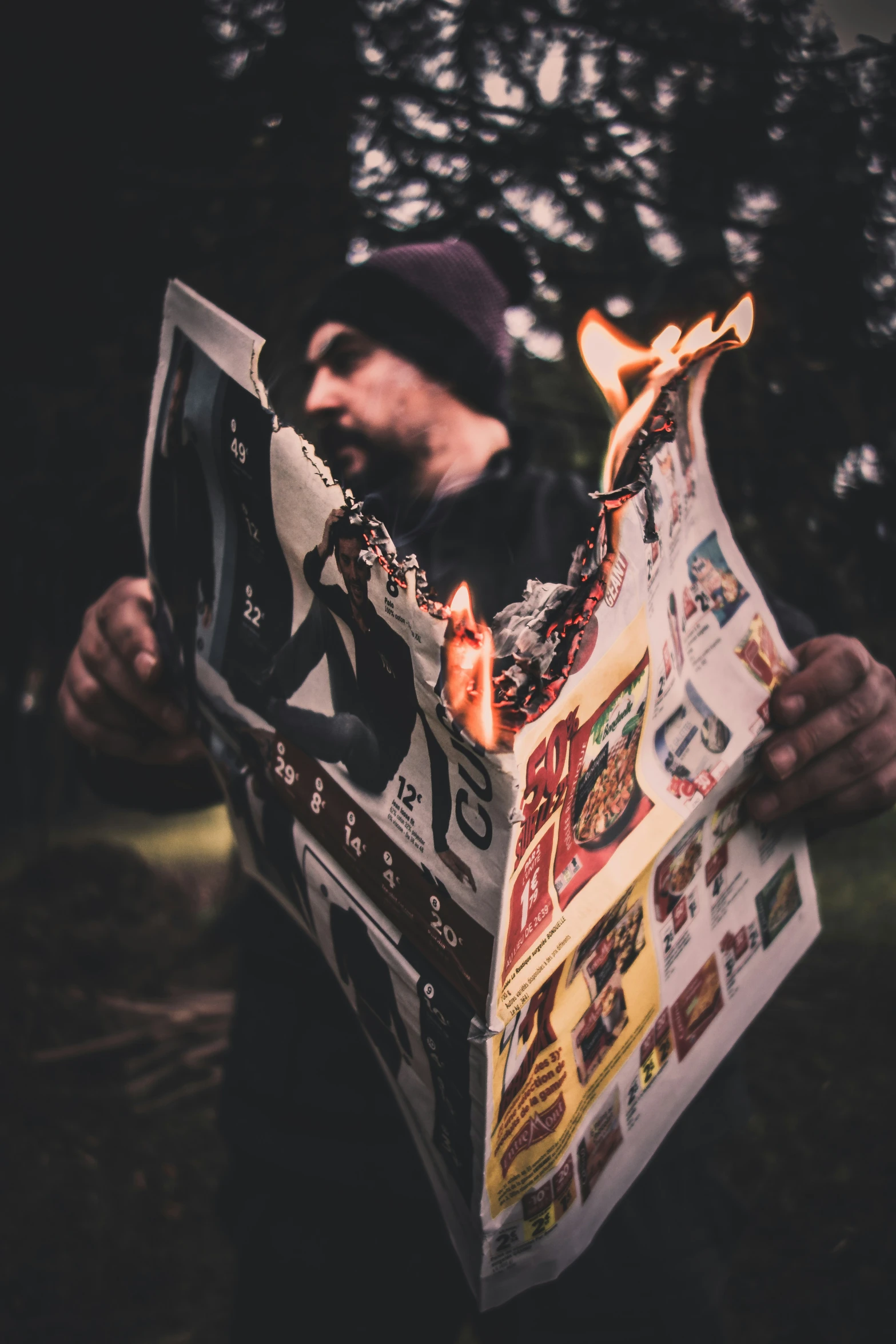 a man in black and white holds an newspaper