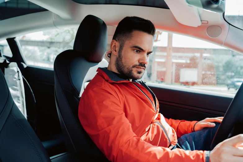 a man sits in the driver seat of a car