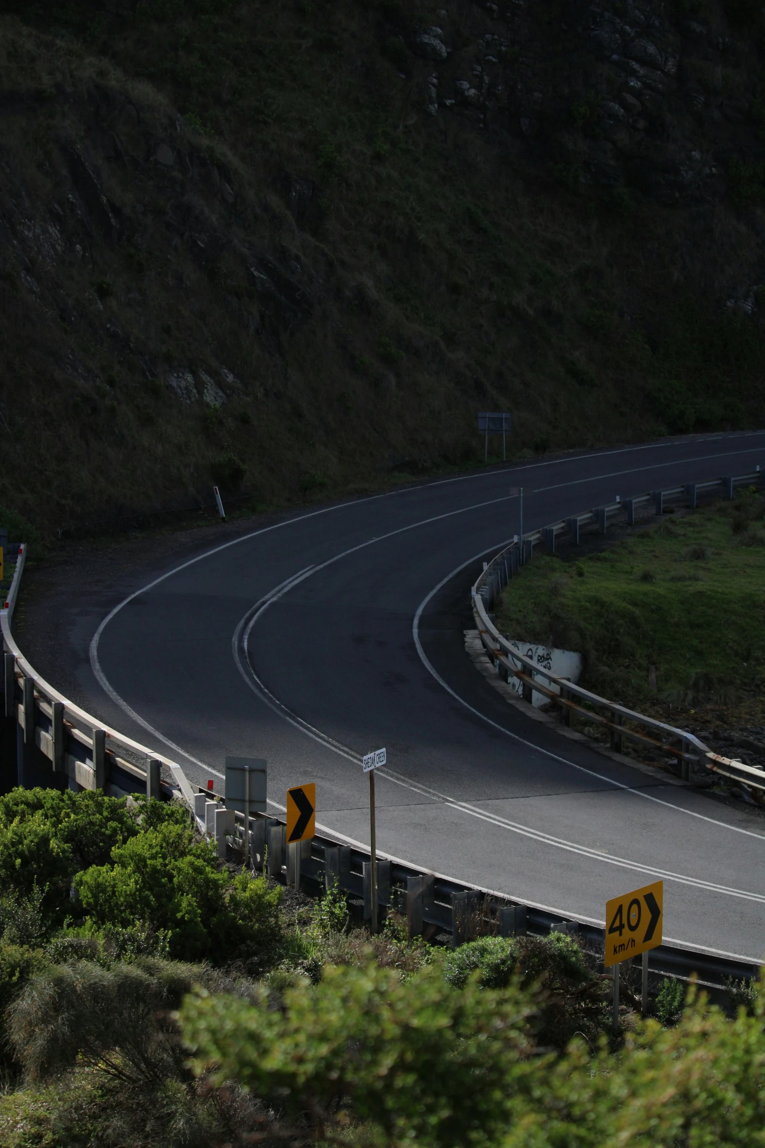 a winding road with two lanes in the mountains