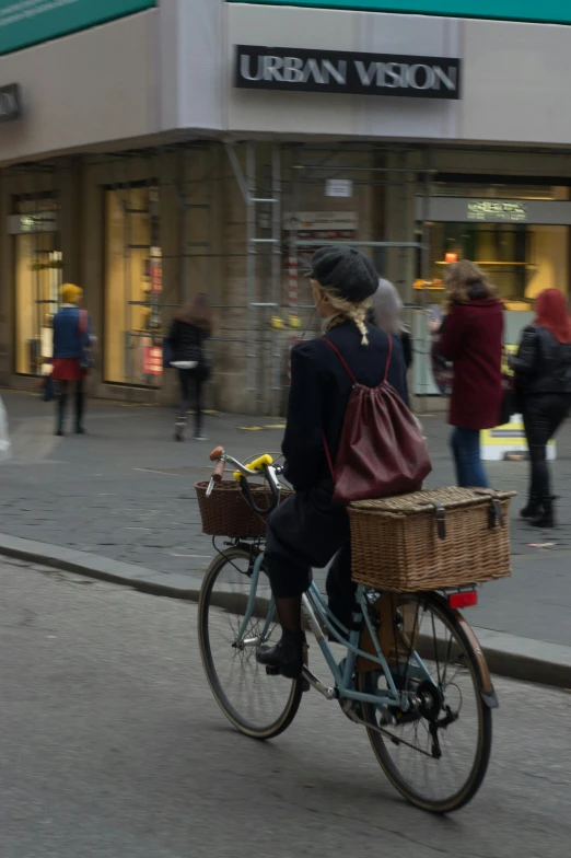 a woman is riding a bicycle on the street