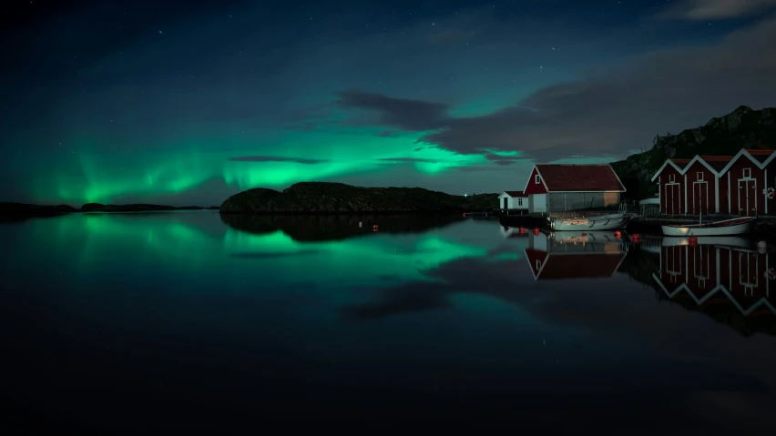 green lights are visible in the sky near the water