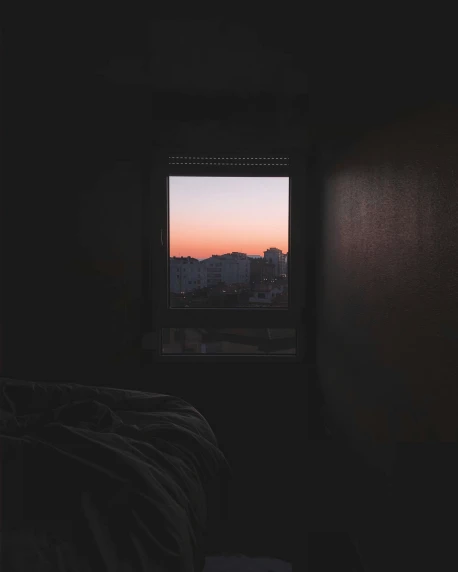 a window view of the city in a dark room