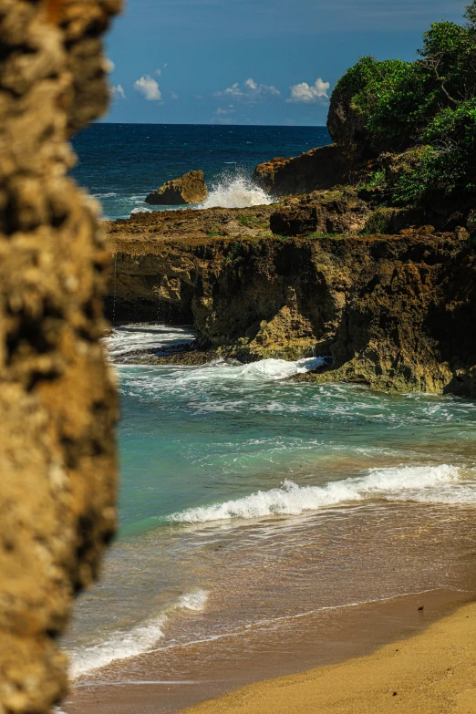 a sandy beach covered in waves and water