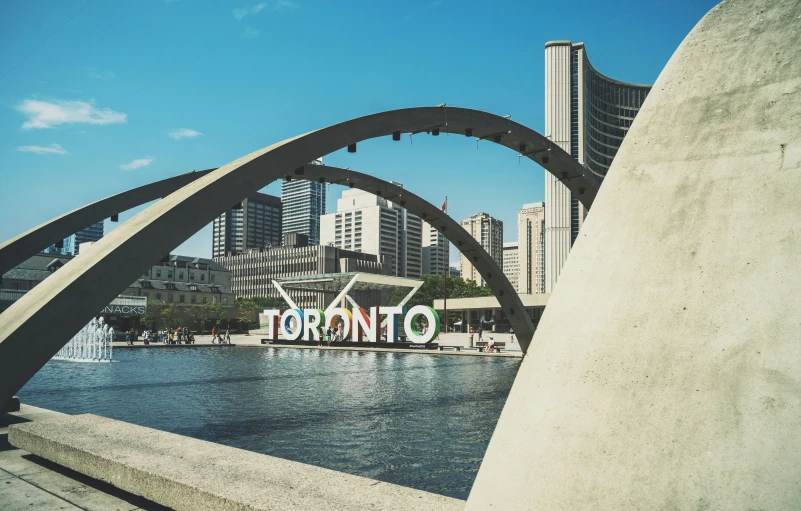 an arch shaped structure in the middle of a lake