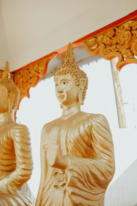 the golden buddhas are at the base of a structure