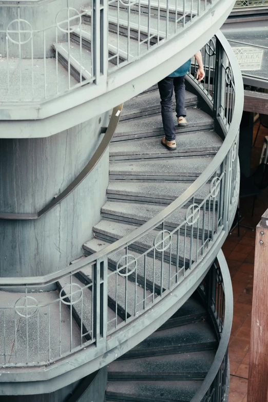 there is a person walking up stairs with their skateboard