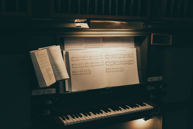 an upright piano is set with a sheet of music