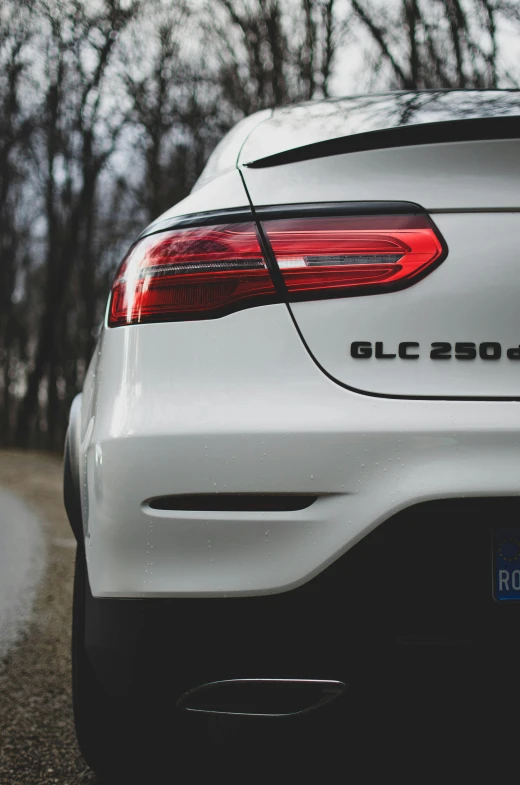 the back end of a white car with the words glc on it