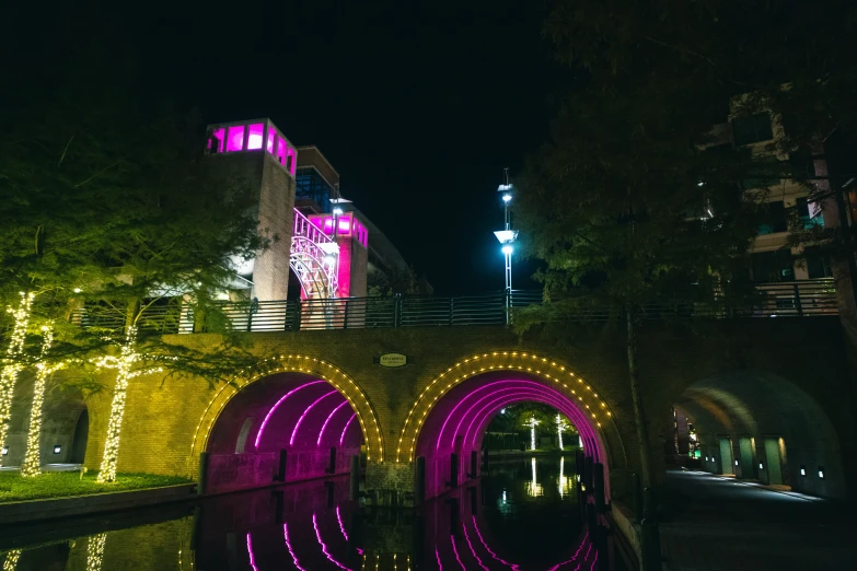 the bridge is covered in lights and the walkway leads up to the tower