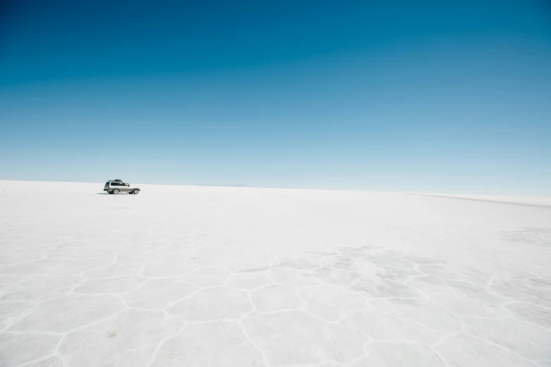 a van on a sandy desert plain in a sunny day