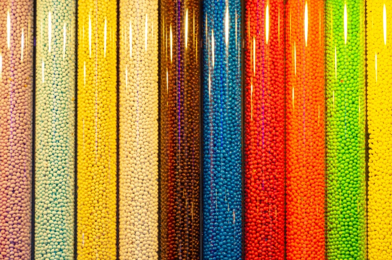 colorful beads are sitting on a display shelf in a store