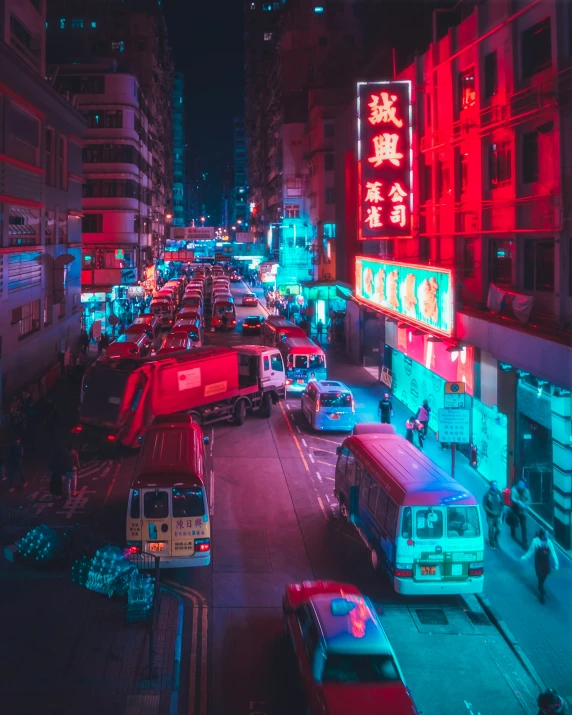 a long line of cars on a street next to tall buildings