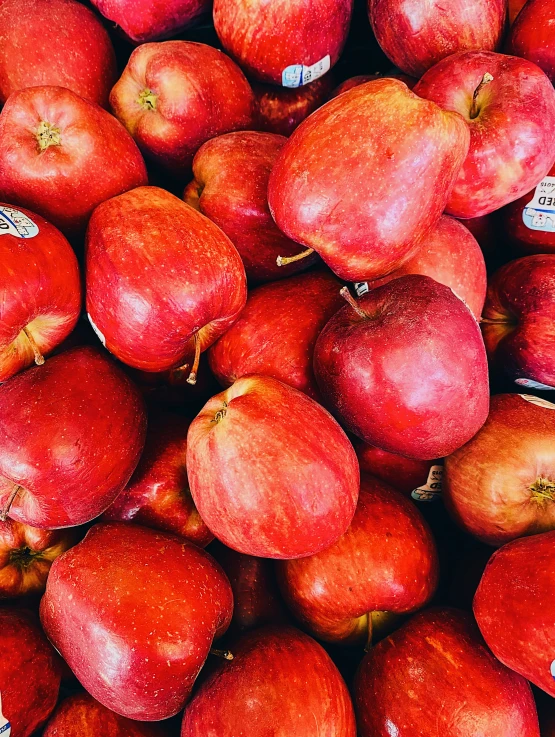 the pile of apples is red in color