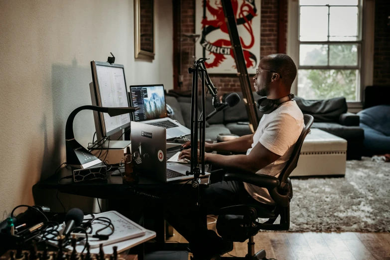 man sitting at computer in loft style living room