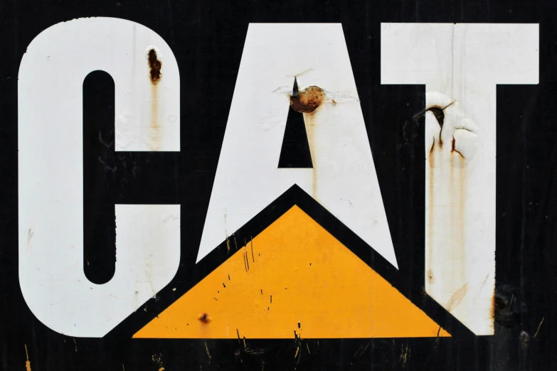 an old rusty sign with a yellow triangle in the center