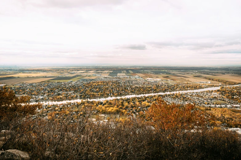 the small city below is nestled among trees and hills