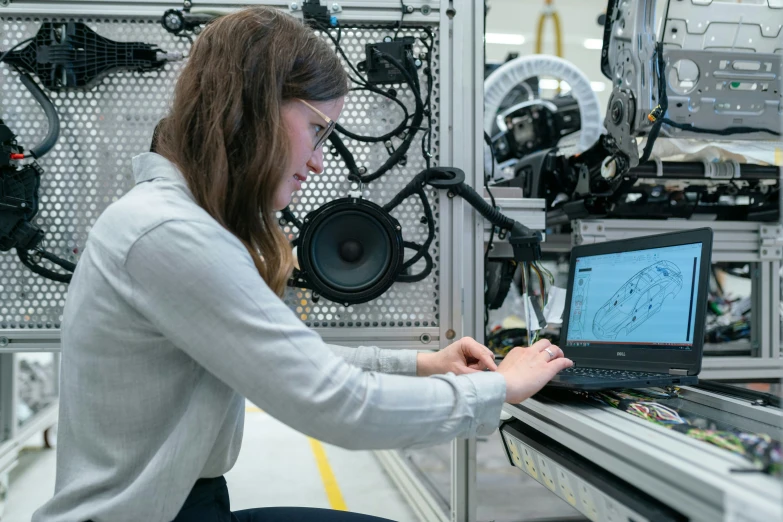 a woman at a computer looking at soing