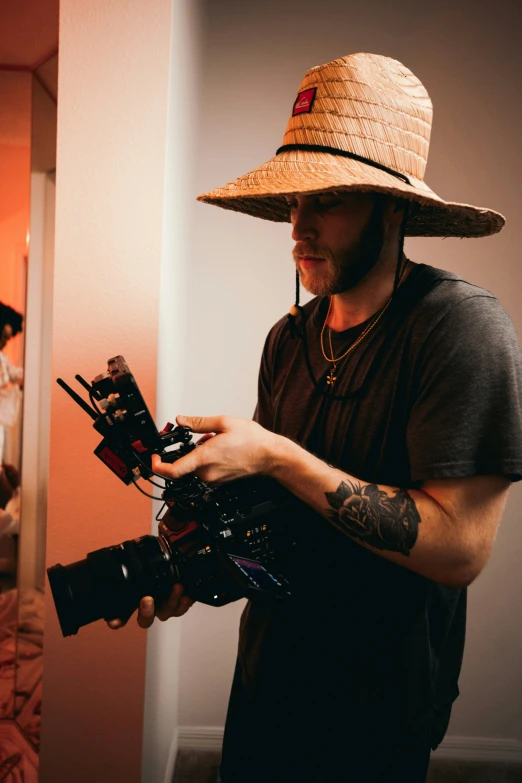 a man with tattooed arms and a camera