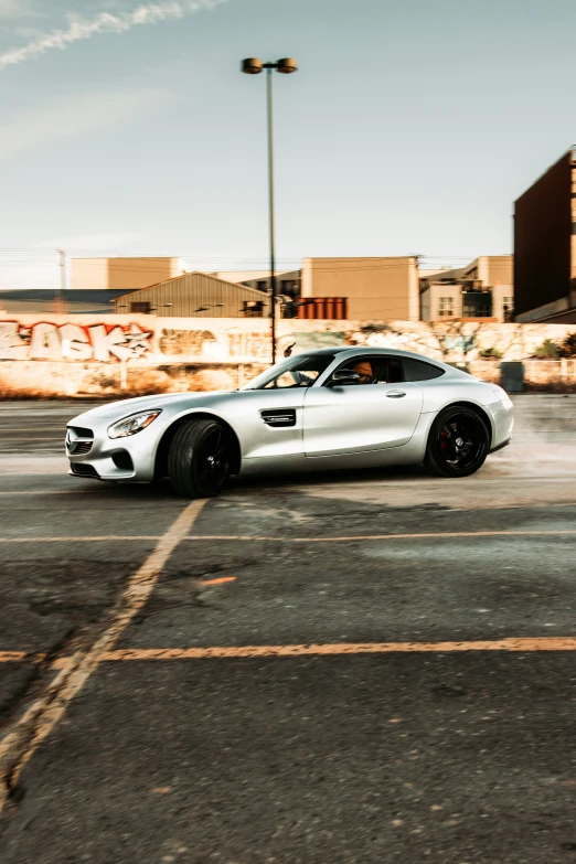 a white sports car traveling through a parking lot