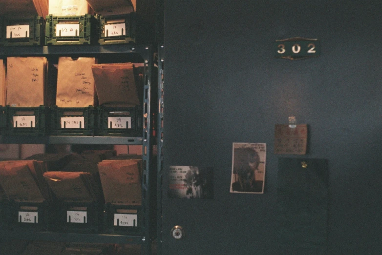 several stacks and boxes on shelves with lights above