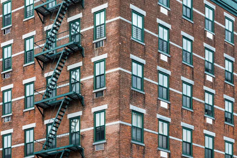 a fire escape is attached to the side of a brick building