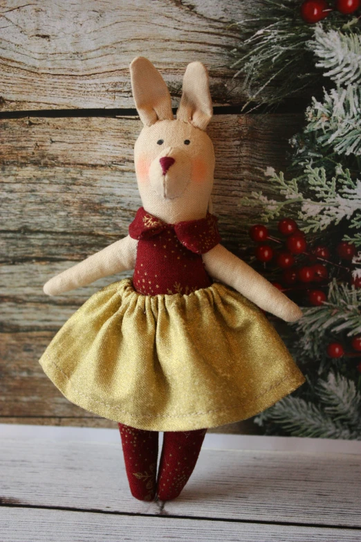 a little bunny doll dressed in a yellow and red dress