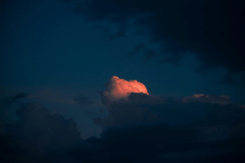 a bright orange cloud with dark blue clouds