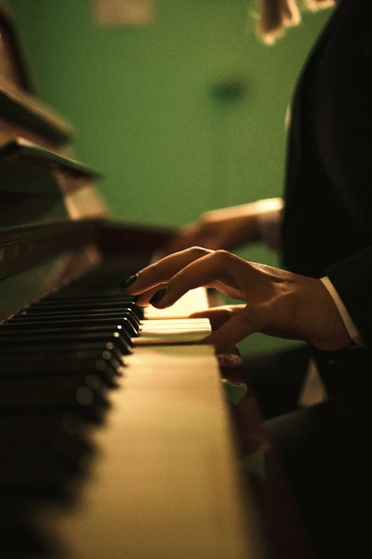 a person is playing the piano in a dark room