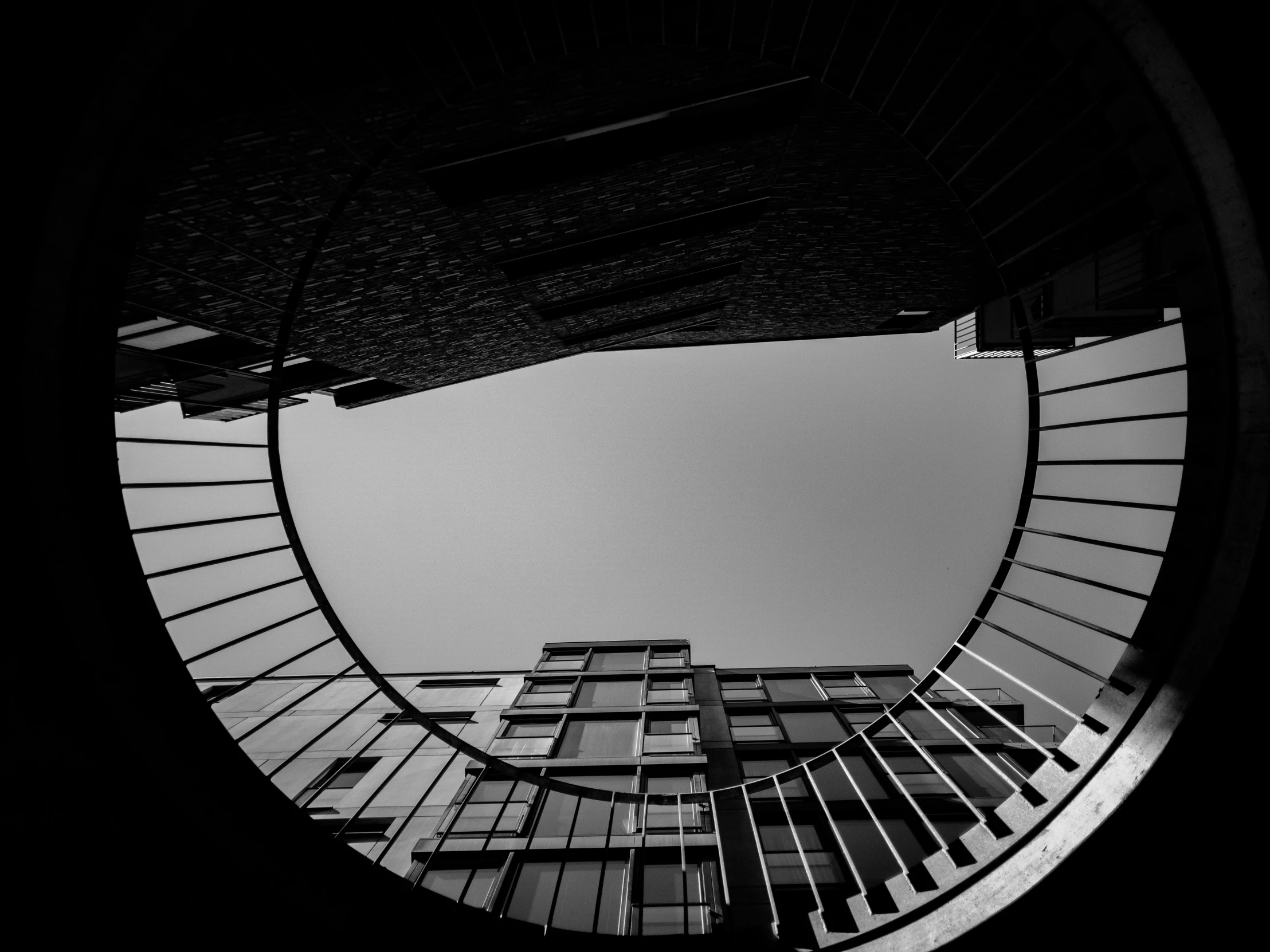 black and white pograph of looking down at an upward staircase