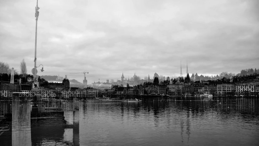 the skyline of a town is reflected in the water