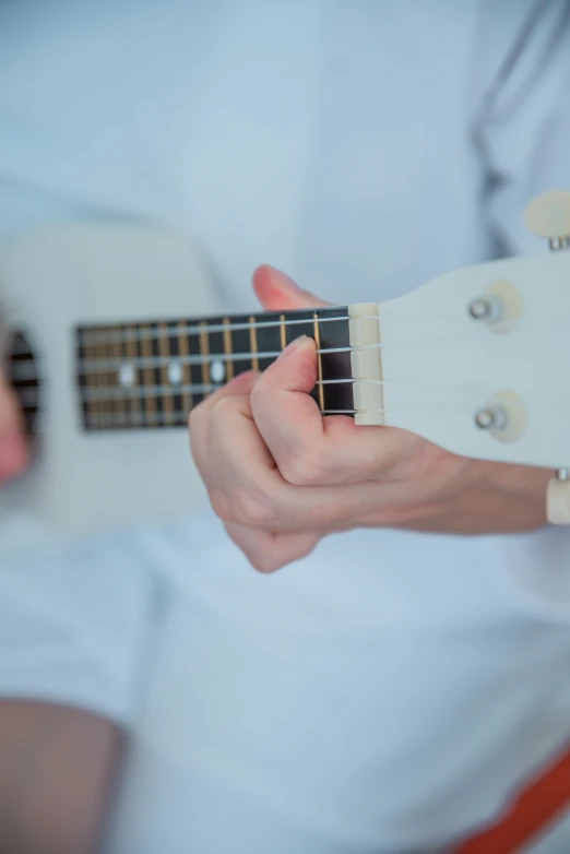 a person holding an acoustic guitar in their hands