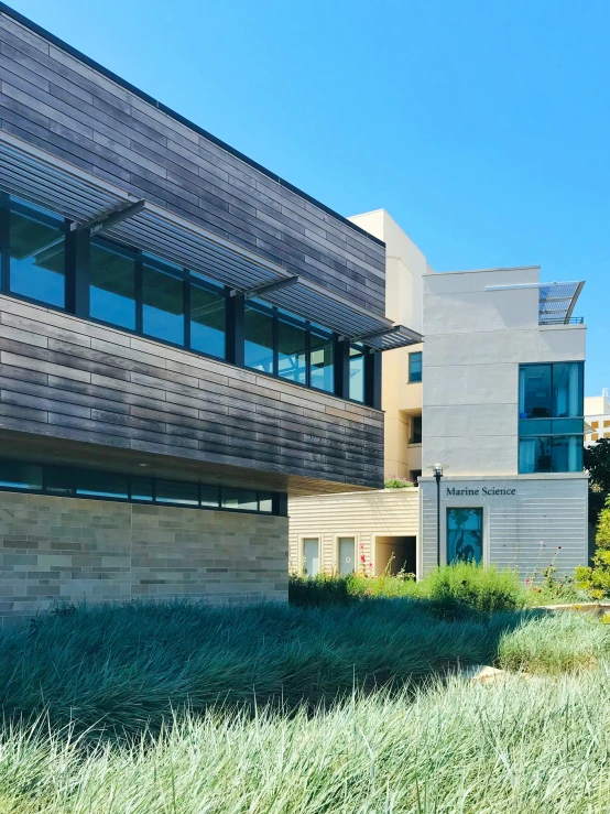 a building sitting above a lush green field