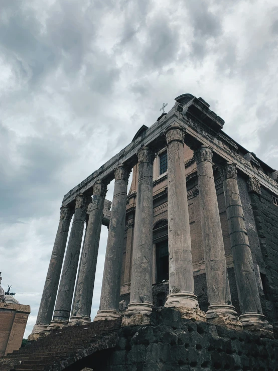 a tall structure with multiple pillars and two people standing in front