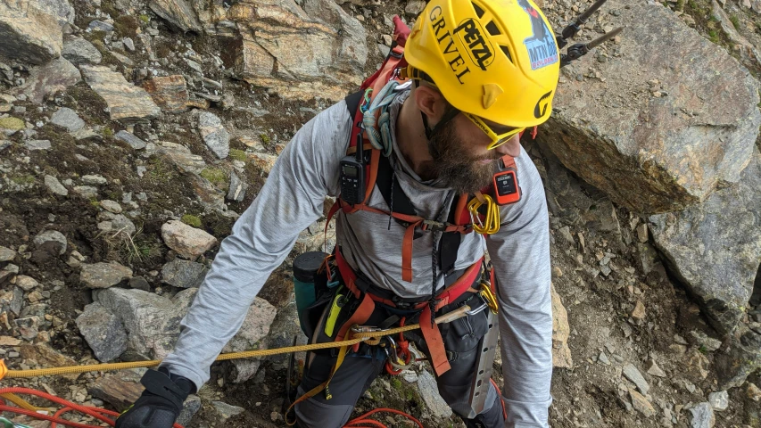 a man with safety gear climbing a mountain