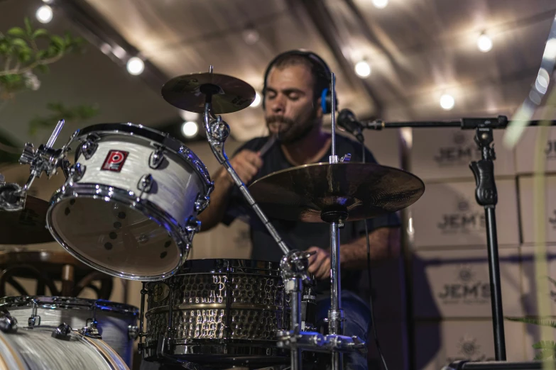 a man with headphones is playing drums