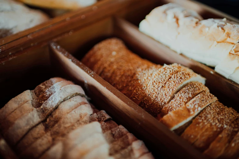 assortment of baked goods displayed in wooden containers