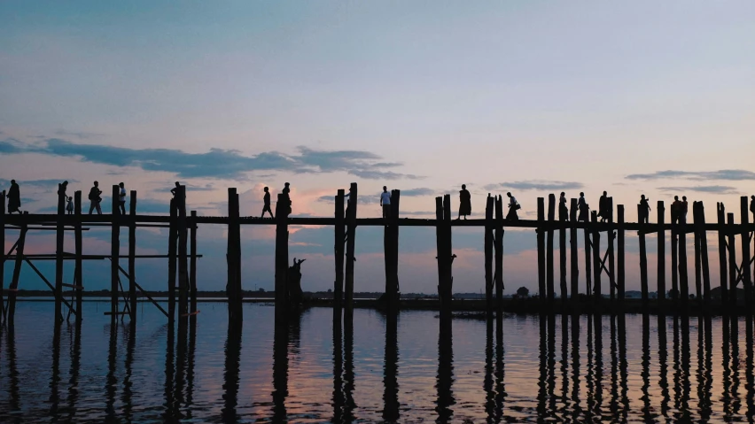 a pier with lots of posts over looking the water